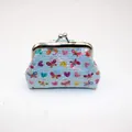 Detailed view of mini clasp coin purse featuring butterfly and heart laser patterns - Blue