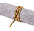 Polished gold square pearl chain necklace with lobster clasp on a grey display stand - 2.5mm Width - 60cm Length / Gold