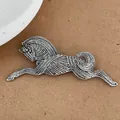 Macro view of vintage silver running horse brooch with embossed metal textures - Silver