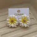 Daisy flower earrings with white glitter petals and yellow centers on a display card - White Yellow