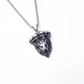 Detail of vintage lion head pendant with four skull accents on stainless steel chain - Skull Style