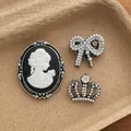 Vintage style brooch set featuring retro cameo, pearl bow, and crown crystal pin - Vintage Brooch Set (B-132) / Silver