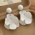 Detailed close-up of large white marble-textured acrylic flower earrings on vintage cards - White (E206)