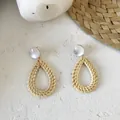 Detail of bohemian waterdrop straw woven earrings with clear acrylic studs on white texture - New Rattan Woven 22 (White Top Teardrop Weave)