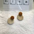 Detail of round rattan woven pendant and wooden stud on bohemian earrings - Round Rattan Woven / Brown Small