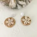 Detailed macro view of bohemian woven earrings with seashell flower and pearl center - Shell Flower Style 3