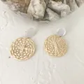 Close-up of woven straw round earrings with white pearl-like acrylic studs on top - Solid Round Disc Style 9