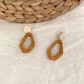 Detail of geometric wood drop earrings on white linen and woven straw background - Geometric Wooden Style (C40)