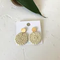 Detail of bohemian rattan drop earrings with golden studs on white display card - Solid Round Rattan (Light Color)