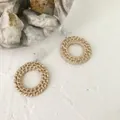 Detail of woven rattan hoop earrings with frosted acrylic studs on textured surface - Hollow Ring Style 10