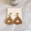Detail of bohemian triangle woven rattan earrings with wood beads on white fabric - Dark Color Triangle Rattan (A131)