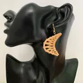 Bohemian crescent rattan drop earrings with golden hooks on black mannequin - Crescent Moon Rattan Style (B43)