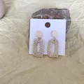 Bohemian woven cream rectangular drop earrings with circular studs on a rock background - Beige Round Post Rectangular Hollow Straw Woven (B41)
