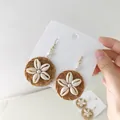 Detail of bohemian shell flower earrings with hand-woven rattan and white pearls - New Woven Rattan Shell Flower Ear Hook (Style 67)