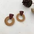 Detail of geometric resin triangle and woven rattan round earrings on white background - Dark Rattan - Wine Red