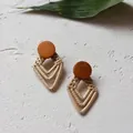 Close-up of handmade bohemian woven rattan diamond earrings with brown wooden discs - New Rattan 32 (Wood Top Beige Rhombus Pattern)