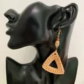 Detail of bohemian triangle woven rattan earrings with wood beads on model - Geometric Rattan Triangle Style (A23)