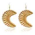 Handmade crescent rattan drop earrings with golden hooks on white reflection surface - Crescent Moon Rattan Style