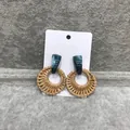 Bohemian round woven earrings with teal marble resin studs on white display card - Dark Rattan Green