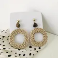 Close-up of Bohemian rattan woven hoop earrings with brown resin beads and gold studs - Coffee Bead Green Vine Style (A98)