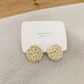 Detail of round woven rattan stud earrings with silver needles on brand card - Light Color Rattan (B27)