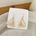 Close-up of geometric triangle woven straw earrings with gold hooks on a display card - Light Color Rattan (B41)
