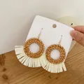 Detail of handmade raffia fringe and woven rattan drop earrings on display card - Dark Color Hollow Round Rattan (A85)