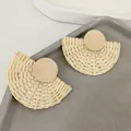 Detail of woven bamboo fan earrings with circular wooden tops on a stone tray - White Woven Fan / White Wood Disc