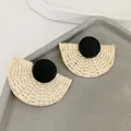 Detailed view of handmade woven rattan fan-shaped earrings with black circular studs - Black Woven Fan / Black Wood Disc