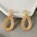 Close-up of golden hammered metal studs and handmade woven rattan teardrop earrings - Dark Teardrop Style (A81)