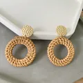 Detail of woven rattan hoop earrings with hammered gold studs on a geometric tray - New Rattan Woven Hammered Top Large Hoop (Style 13)