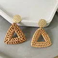 Macro shot of geometric rattan triangle earrings with gold-tone hammered metal detail - New Rattan Woven 16 (Hammered Gold Triangle)
