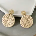 Detail of woven rattan hoop earrings with gold-textured metal studs and bohemian finish - New Rattan Woven 57 (Hammered Gold Disc Pendant)