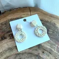 Detailed close-up of handmade woven rattan earrings with geometric cream wooden beads - Geometric Wood Bead Circle Style (A132)