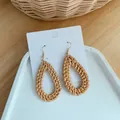 Detailed view of handmade teardrop straw woven earrings with golden hooks on white card - Dark Waterdrop Woven Style (B26 Waterdrop)
