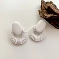 Minimalist white geometric spiral drop earrings with textured matte finish for women - Coil Shape / White