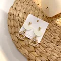 Handmade woven triangle drop earrings with gold studs and straw texture on a jewelry card - New Woven Rattan 23 (Triangle Gold Bead Pendant)