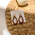 Retro geometric wooden drop earrings in dark brown and cream on a jewelry card - Red-Brown Style