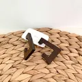 Brown wooden C-shaped geometric earrings with natural grain on a straw textured background - Geometric C Shape Style (C21)