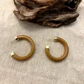 Retro C-shape wooden hoop earrings with gold metal caps on a natural textured linen background - 3.5cm Diameter / Brown