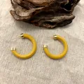 Retro C-shaped wooden hoop earrings in mustard yellow with gold ends on linen background - 3.5cm Diameter / Yellow