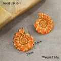Detail view of 18K gold plated conch earrings with orange enamel, size 3.4cm by 2.9cm - 18K Gold / Orange Conch Stud Earrings (NMSE-J3410-1)