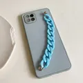 Detail of light blue candy-colored plastic chain strap on a matte mobile phone case - Blue