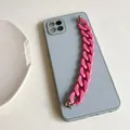Detail of blue grey phone case featuring a chunky matte pink plastic chain handle - Rose Red