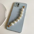 Blue phone case with elegant white pearl strap and gold metal rings on a white background - G306 White Pearl