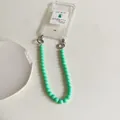 Mint green candy colored beaded phone strap with detachable metal rings on clear case - Turquoise Green