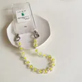 Chic floral phone strap with transparent acrylic flower beads and white pearls on a case - Yellow Flower