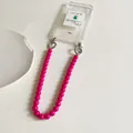Detail of pink resin beaded phone strap with silver spring clasps on a clear case - Rose Red