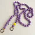 Detail of purple beaded phone strap with yellow accent bead and silver Love charm - Purple