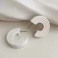 Minimalist white C-shaped hoop earrings with concentric textured layers and silver pins - White